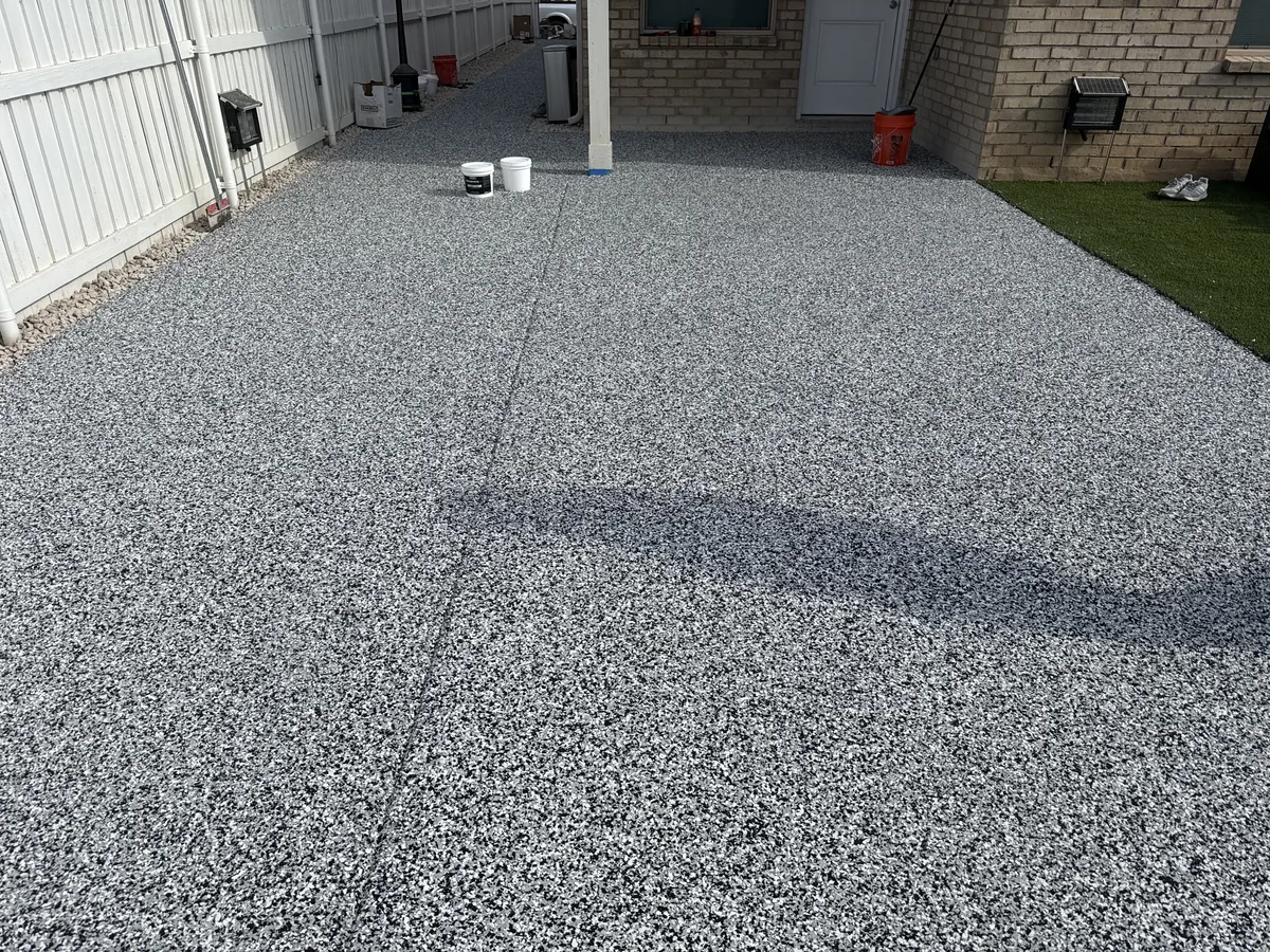 Concrete patio finished with a gray and white flake floor epoxy coating