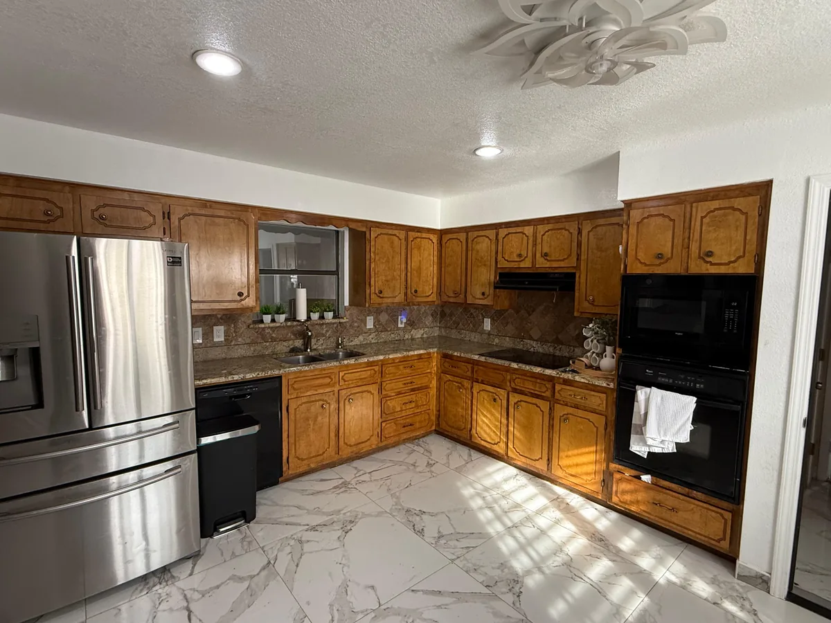Kitchen with wood cabinets before any painting work